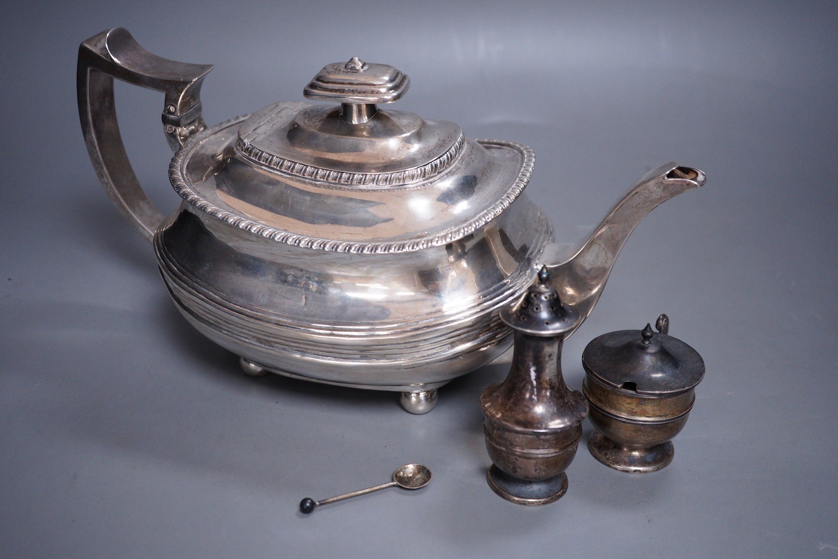 A Georgian silver teapot, (marks rubbed and repaired) and two Edwardian silver condiments, gross weight 23.3oz.